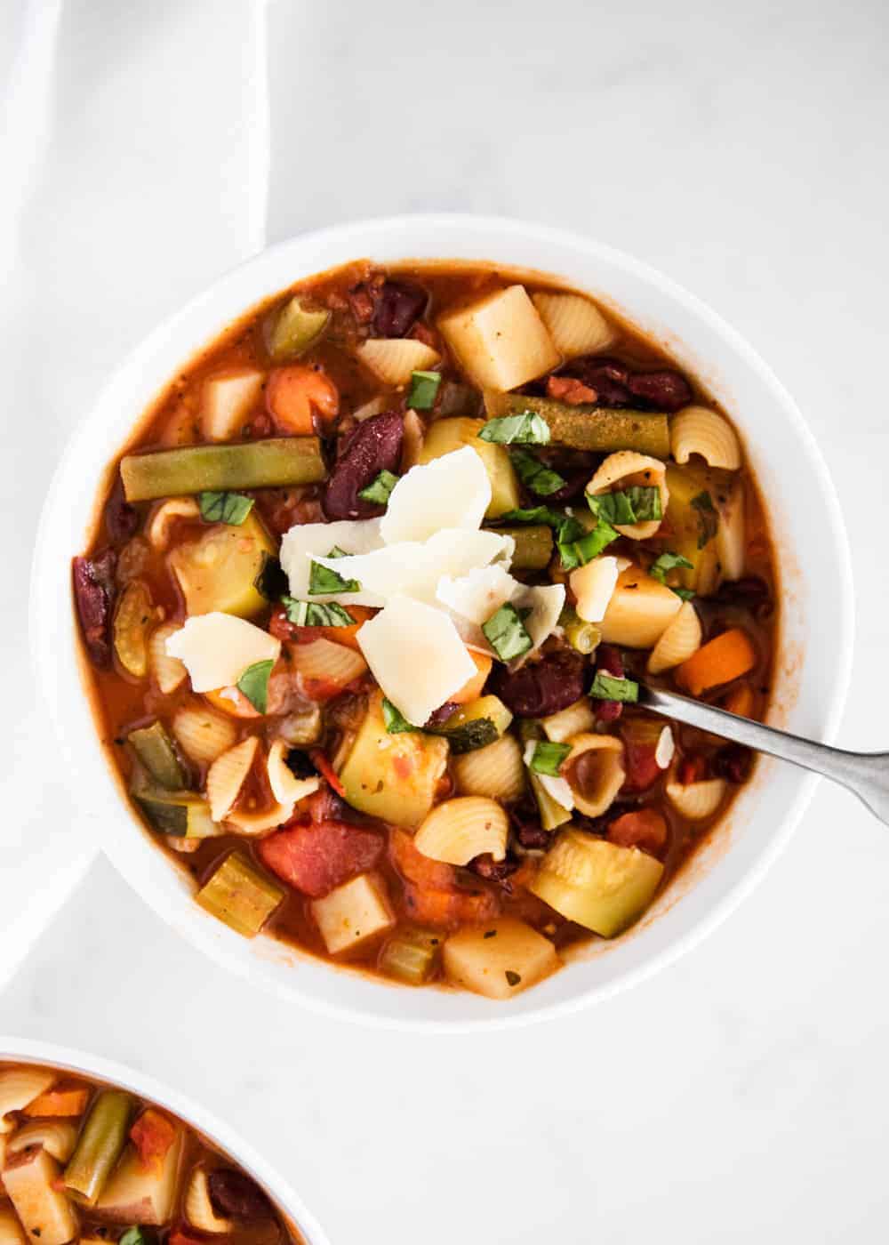 Bowl of Italian minestrone soup with fresh parmesan.