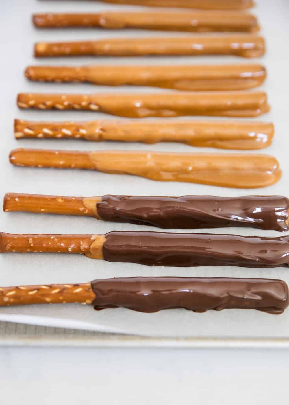 Caramel and chocolate dipped pretzel rods.