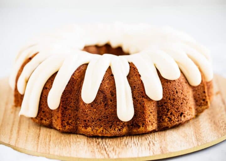 Soft and moist pumpkin bundt cake topped with a rich cream cheese frosting. This easy and delicious cake makes a great fall dessert! pumpkin bundt cake with cream cheese frosting