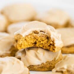 iced pumpkin cookies with a bite taken