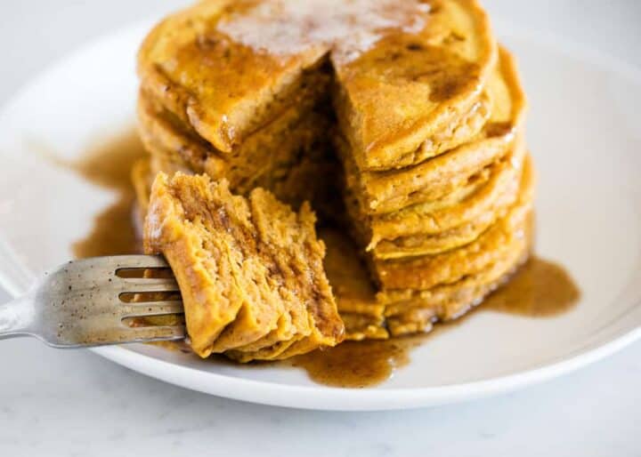 stack of pumpkin pancakes with a fork