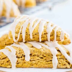 glazed pumpkin scones stacked on a plate