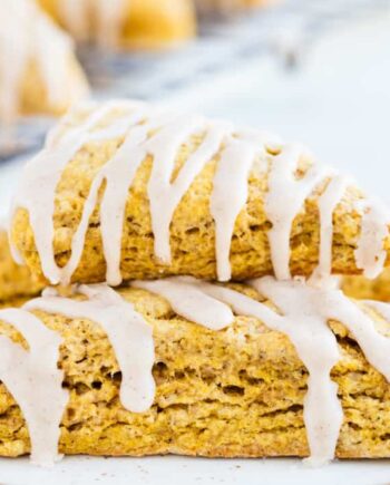 glazed pumpkin scones stacked on a plate