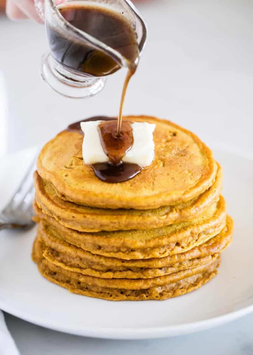 stack of pumpkin spice pancakes with butter and syrup
