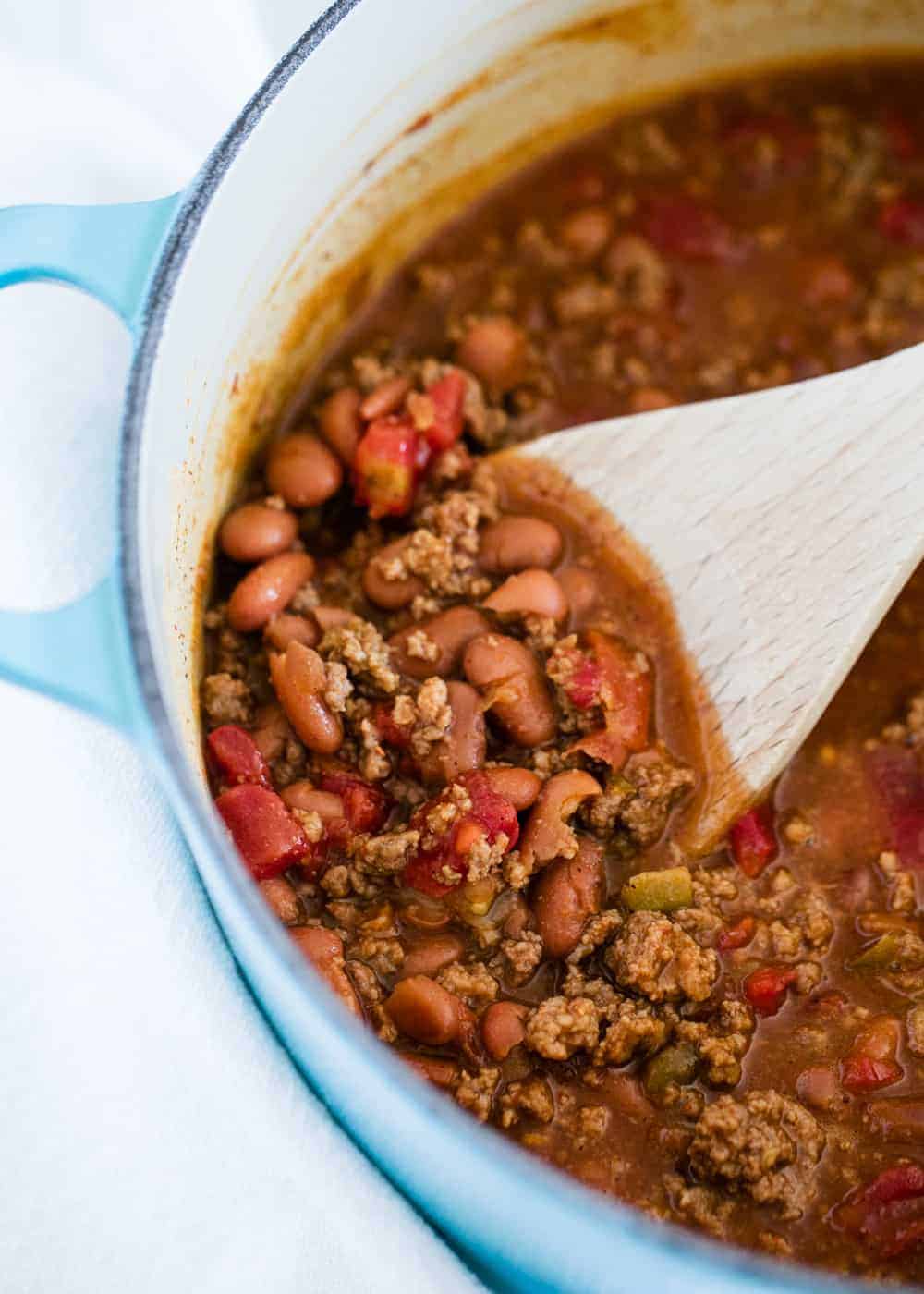 Chili in a pot with wooden spoon.