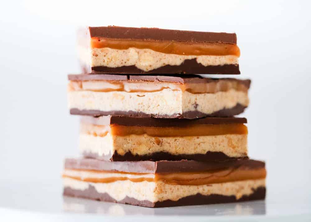 Stack of homemade snickers bars.