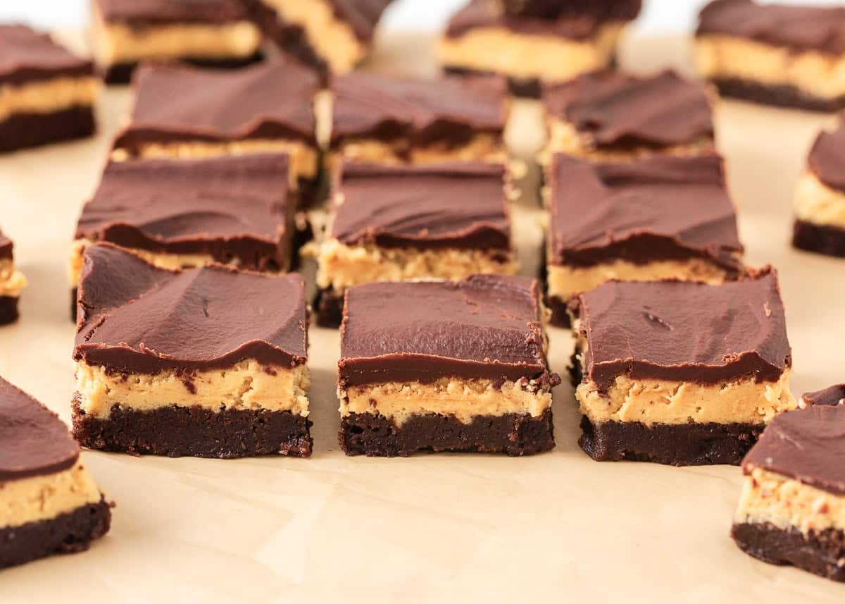 Buckeye brownies recipe cut into squares on parchment paper.
