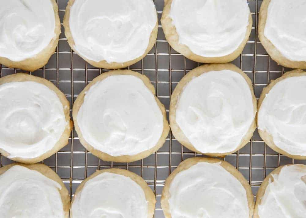 frosted ricotta cookies on a cooling rack 