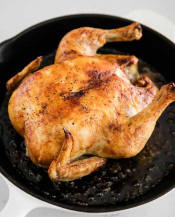 whole roasted chicken in a cast iron pan
