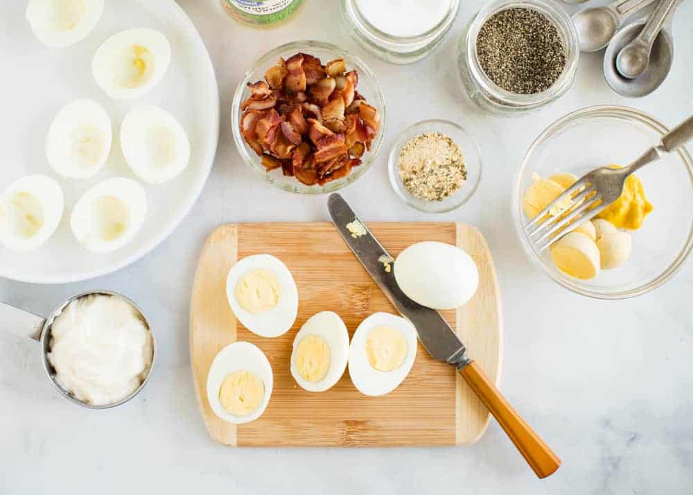 ingredients for making bacon ranch deviled eggs out on counter 