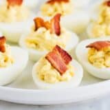 bacon ranch deviled eggs on a white plate