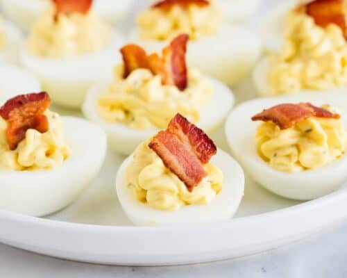 bacon ranch deviled eggs on a white plate