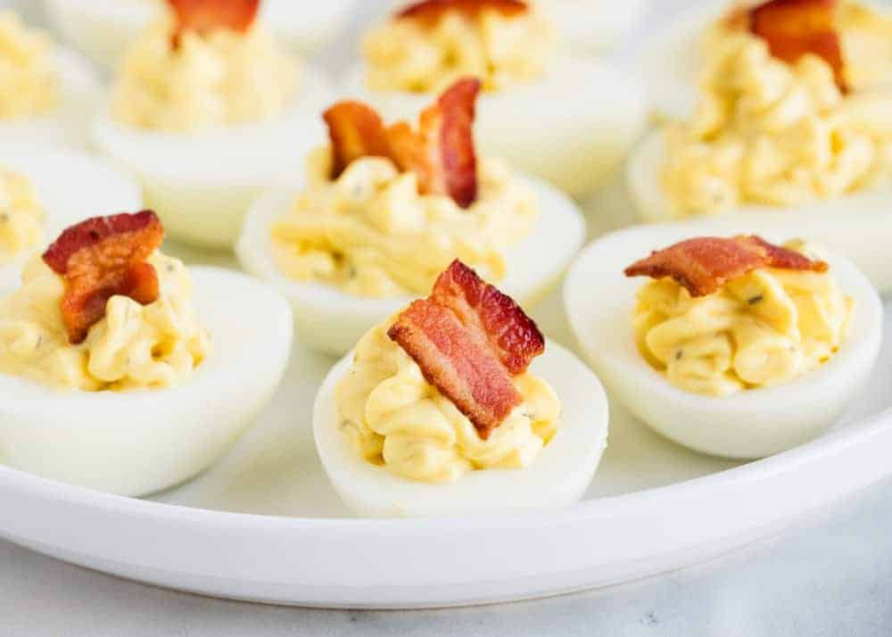 bacon ranch deviled eggs on a white plate 