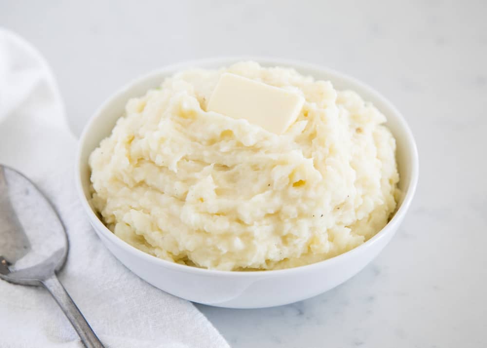 Creamy mashed potatoes in a white bowl.