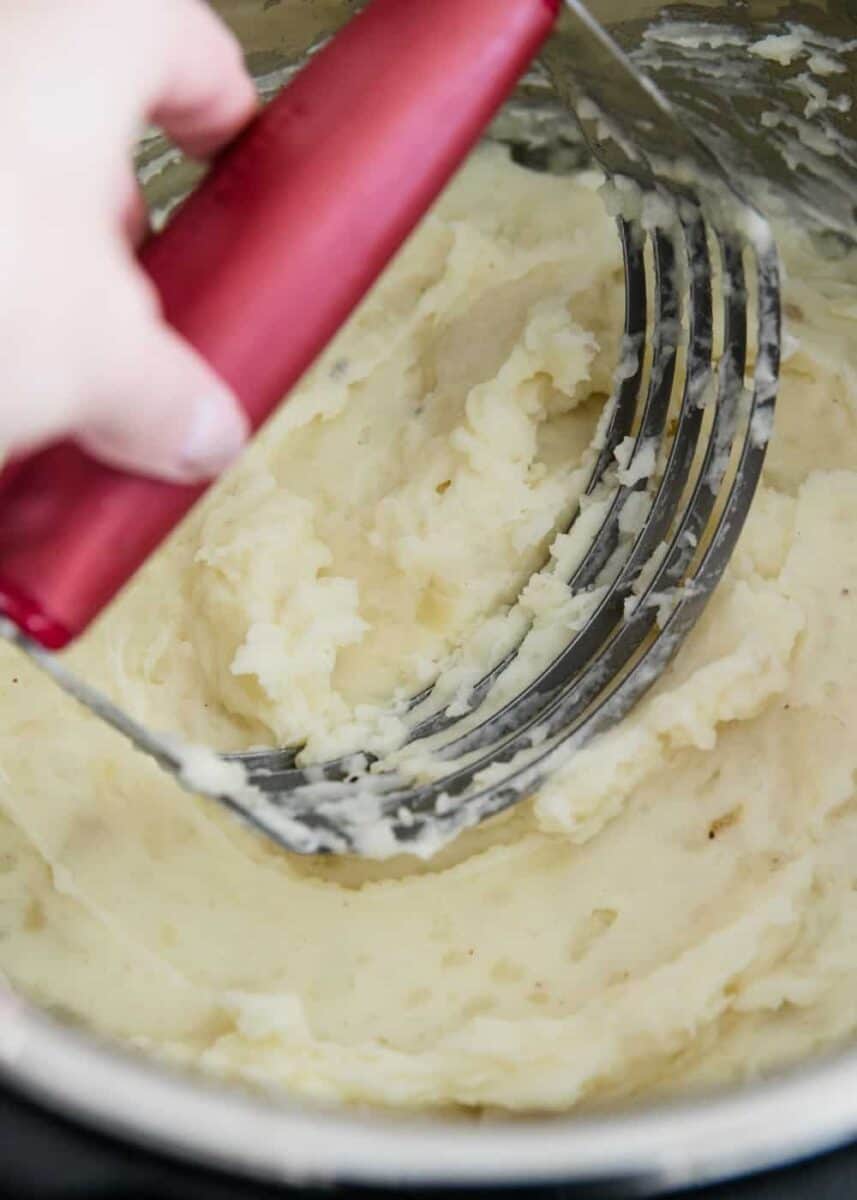 potatoes being mashed in the instant pot