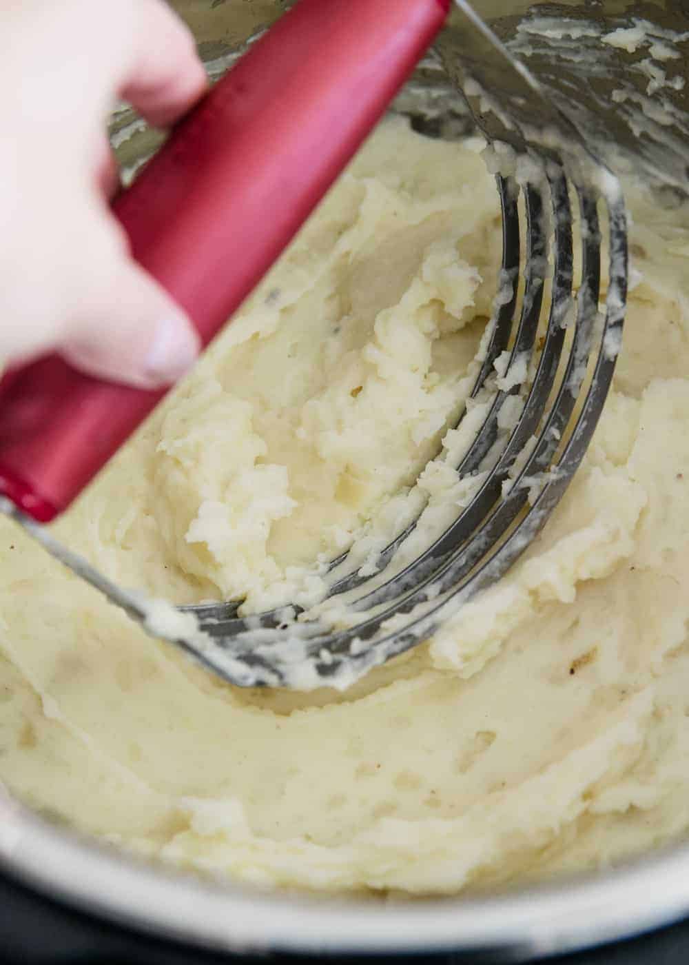 Potatoes being mashed in the instant pot.