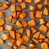 close up of roasted sweet potatoes on baking sheet