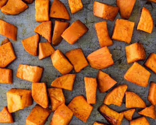 close up of roasted sweet potatoes on baking sheet