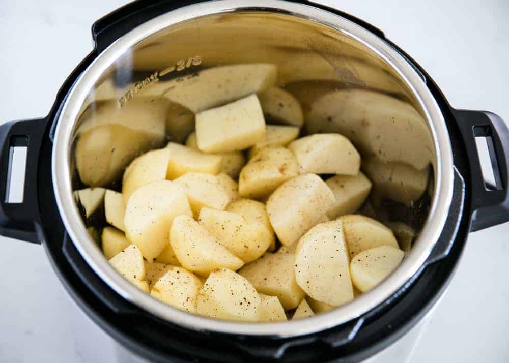 Sliced potatoes in instant pot with pepper.