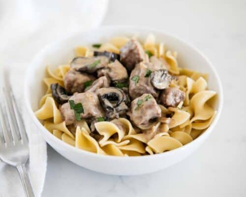 bowl of beef stroganoff served over egg noodles