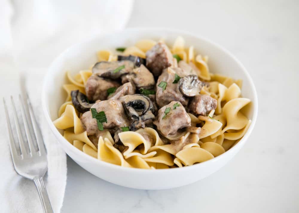 Bowl of beef stroganoff served over egg noodles.