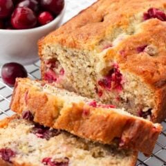 Sliced cranberry banana bread on a cooling rack.