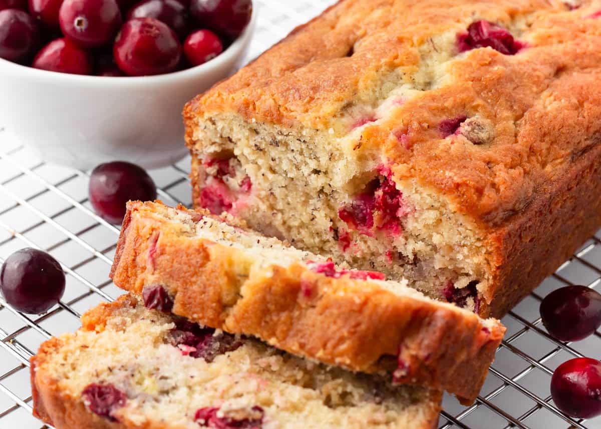 Sliced cranberry banana bread on a cooling rack.
