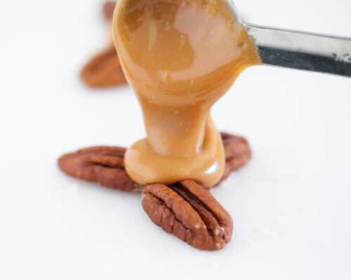 pouring caramel over pecans