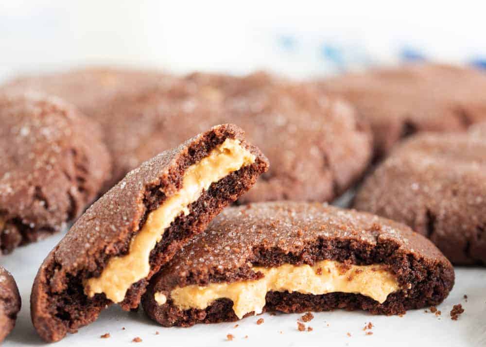 A rich and flavorful chocolate cookie filled with a delicious soft peanut butter center. These decadent peanut butter stuffed cookies are an absolute dream! Peanut butter filled chocolate cookies.