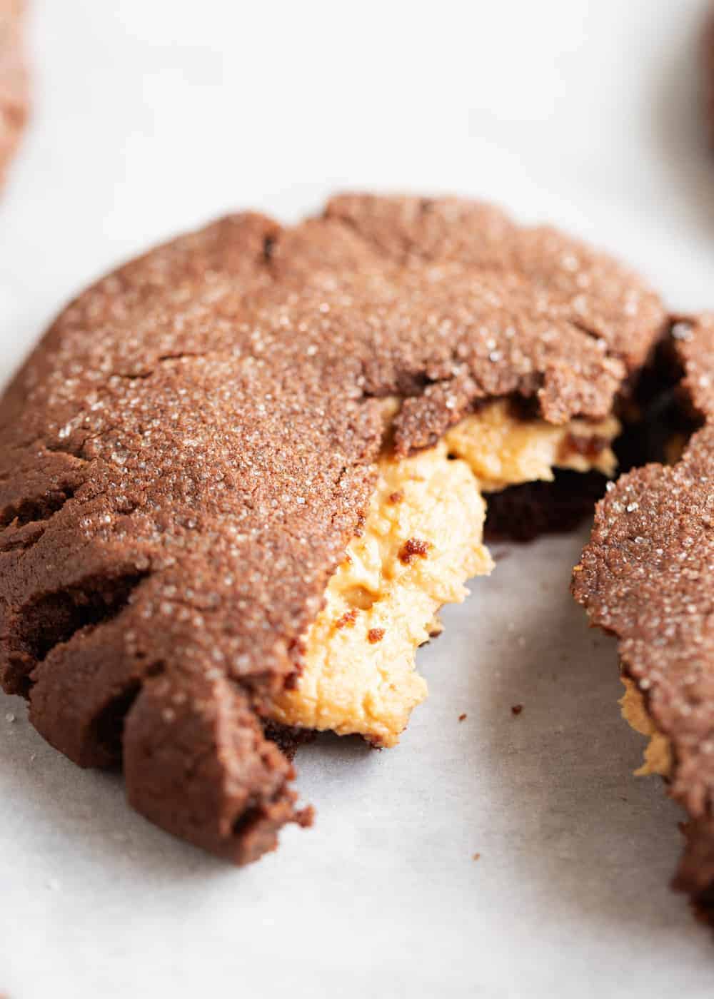 Peanut butter filled cookie torn in half.