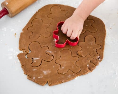 cutting out gingerbread cookie dough