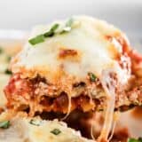 A close up of a slice of lasagna