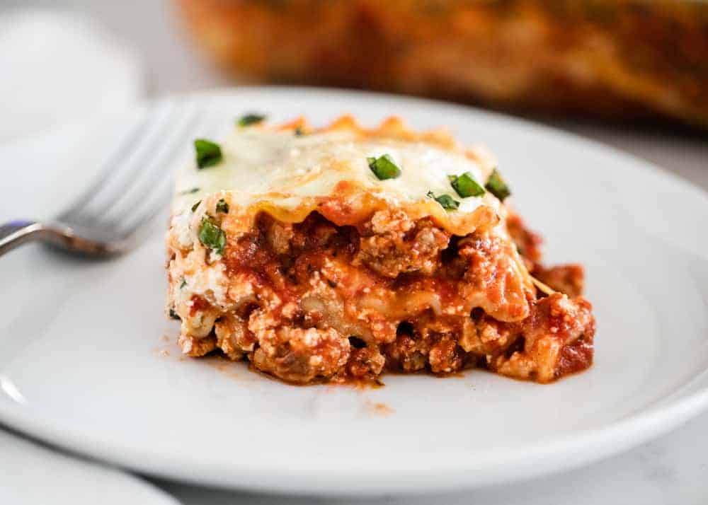 Lasagna on a white plate.