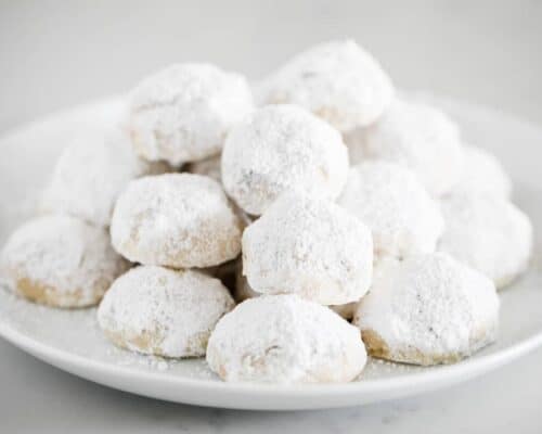mexican wedding cookies on white plate