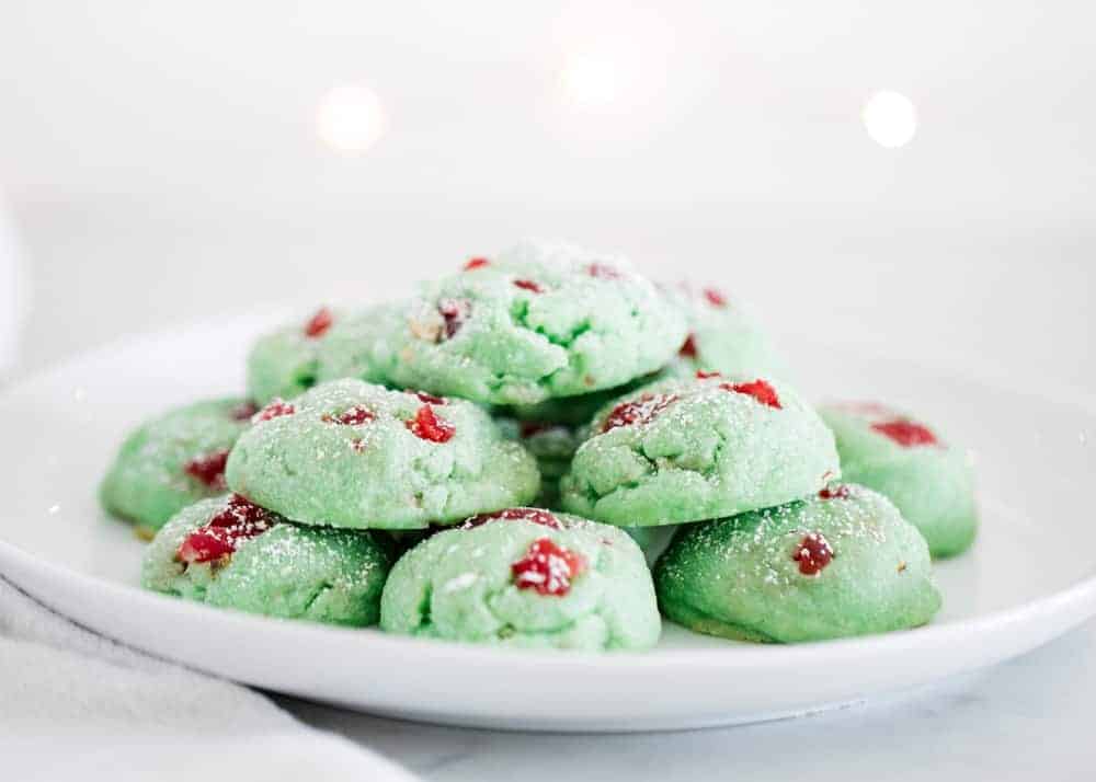 Pistachio pudding cookies stacked on white plate.