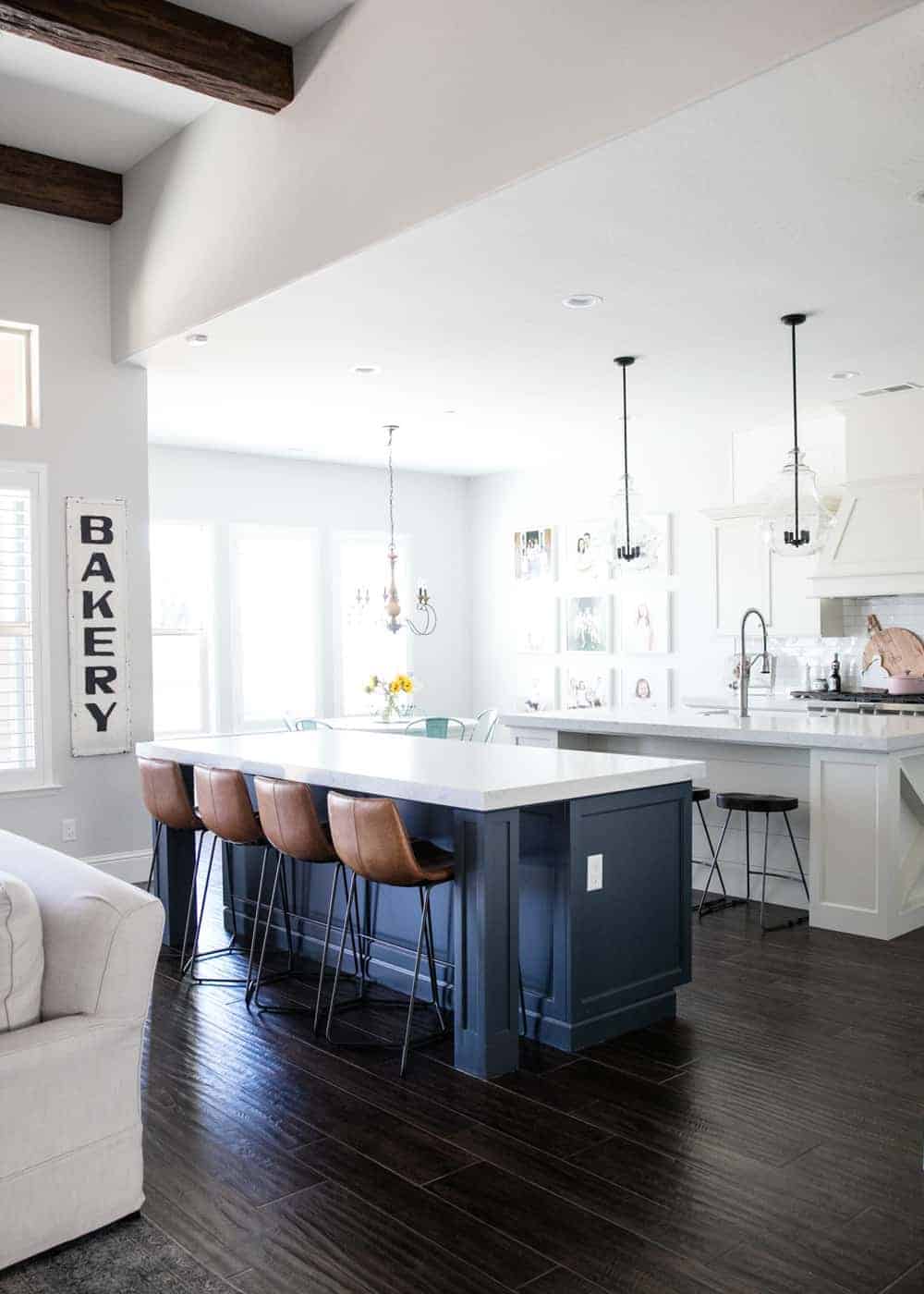 A kitchen with two islands and a large window 