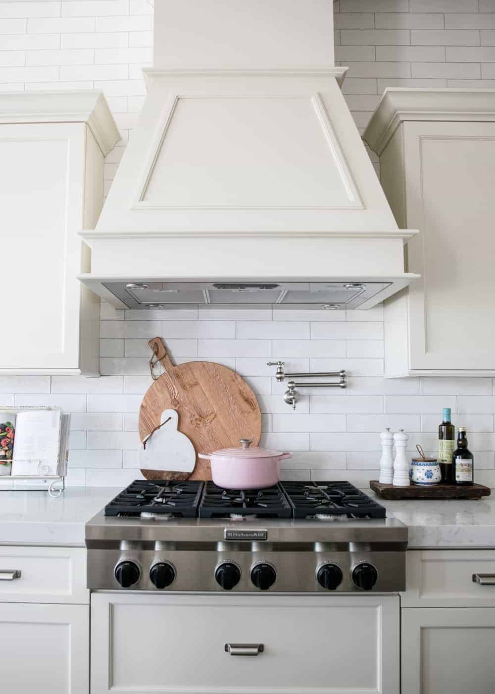 whit subway tile backsplash behind stove