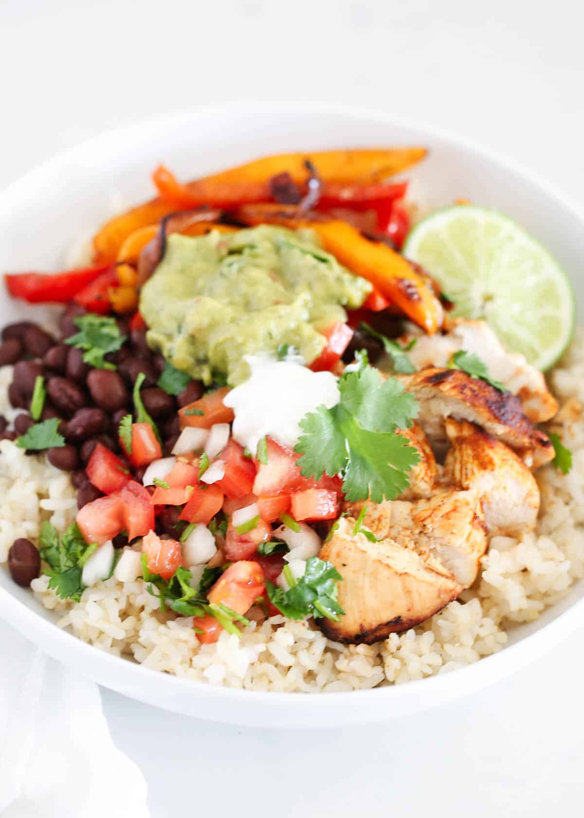 Chicken fajita bowl with toppings.