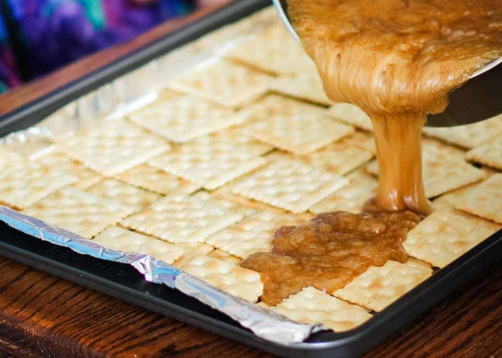 toffee being poured over crackers