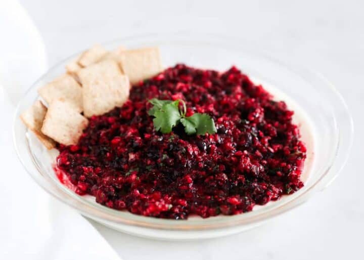 cranberry salsa in glass dish with crackers