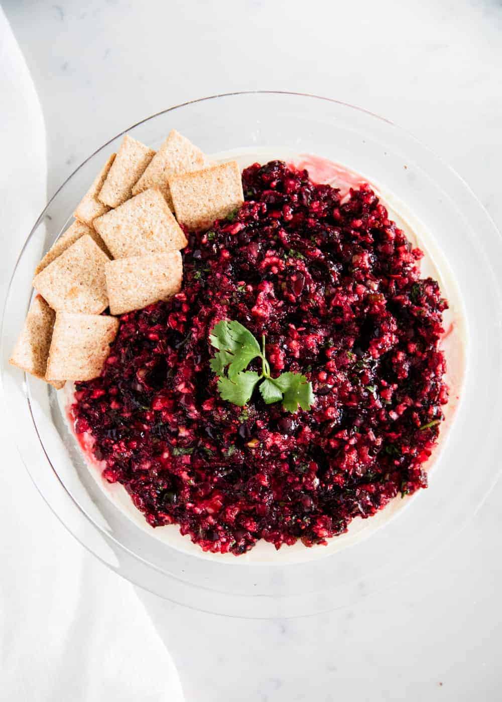 Cranberry salsa with cilantro and crackers.