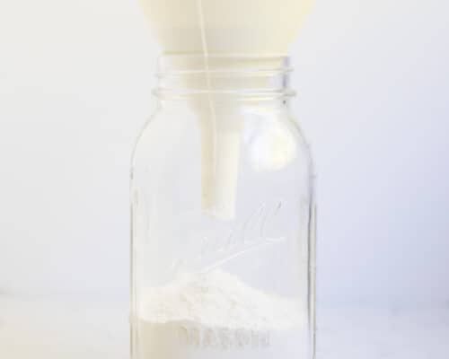 funneling flour in jar