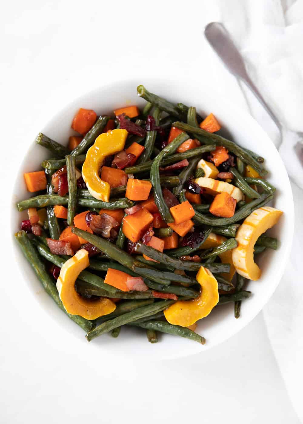 Maple roasted vegetables in a white bowl.