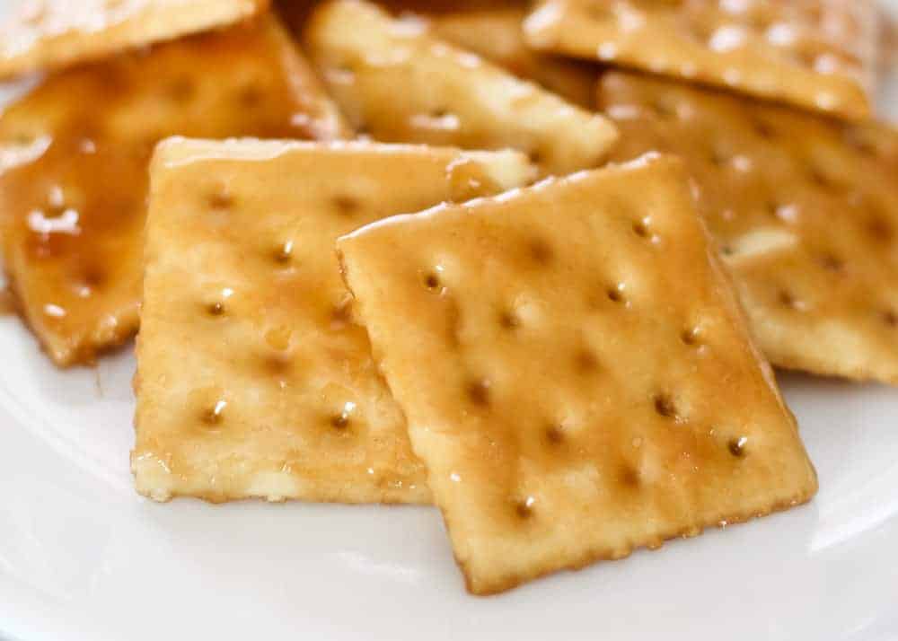 Saltine cracker toffee on white plate.