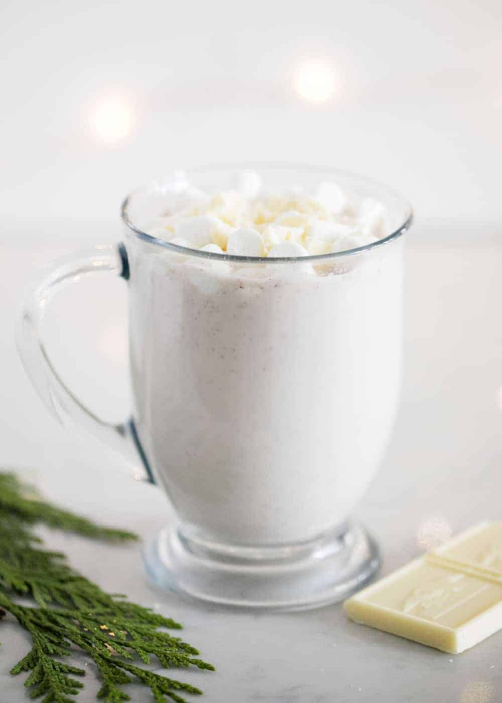 Snickerdoodle hot chocolate in a clear mug.