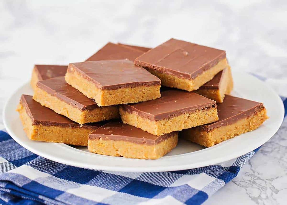 A plate of no bake peanut butter bars cut into squares.