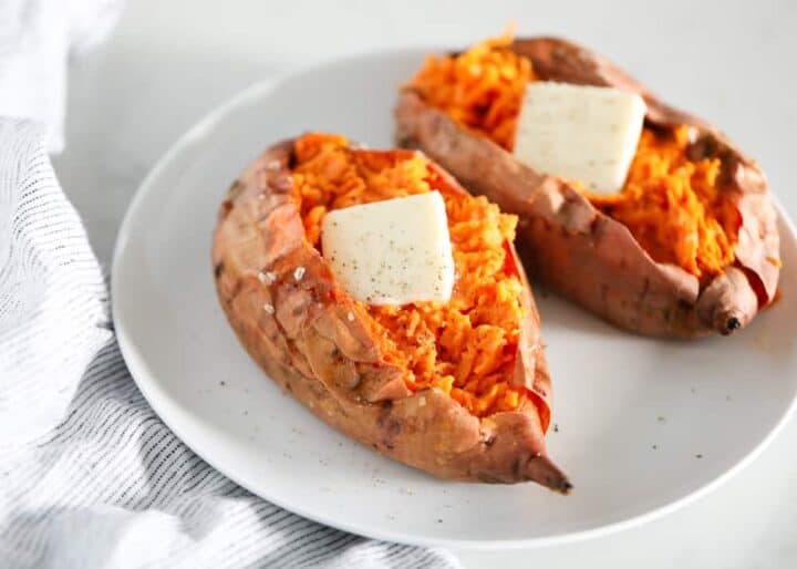 baked sweet potatoes with butter on a white plate 