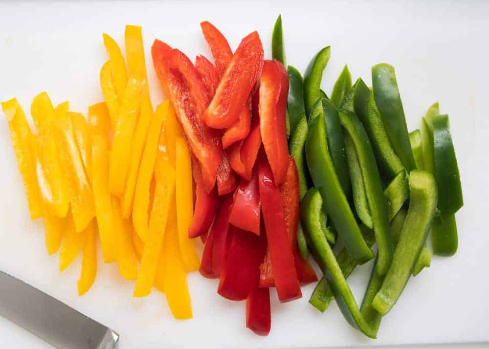 Sliced bell peppers on a cutting board.