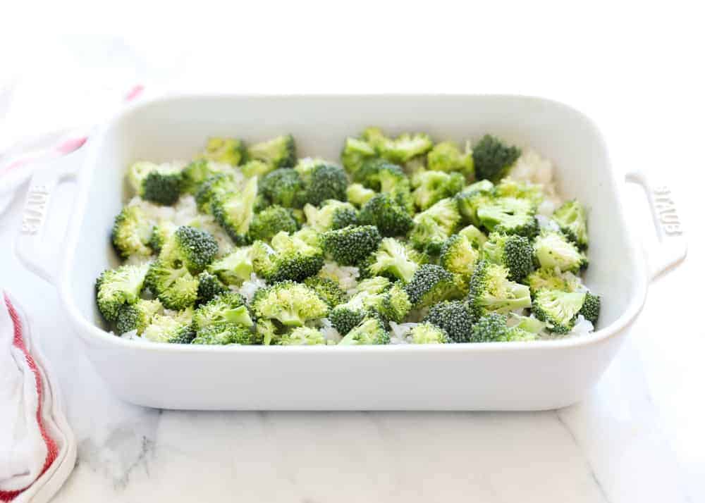 Broccoli and rice in a white casserole dish.