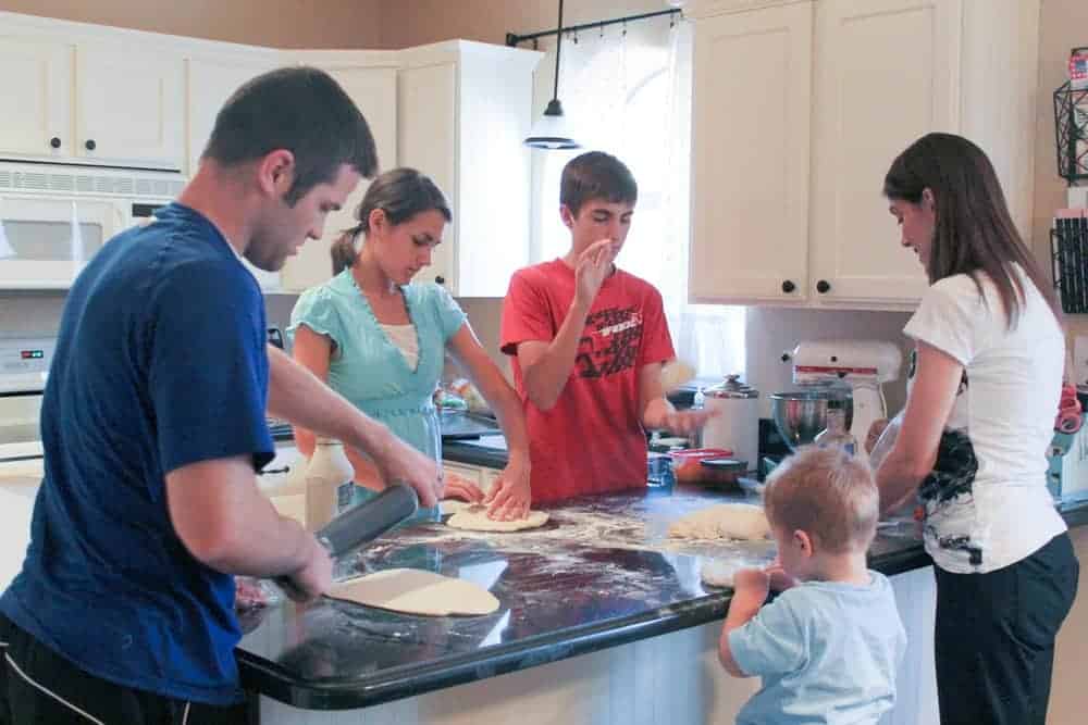 family making pizza